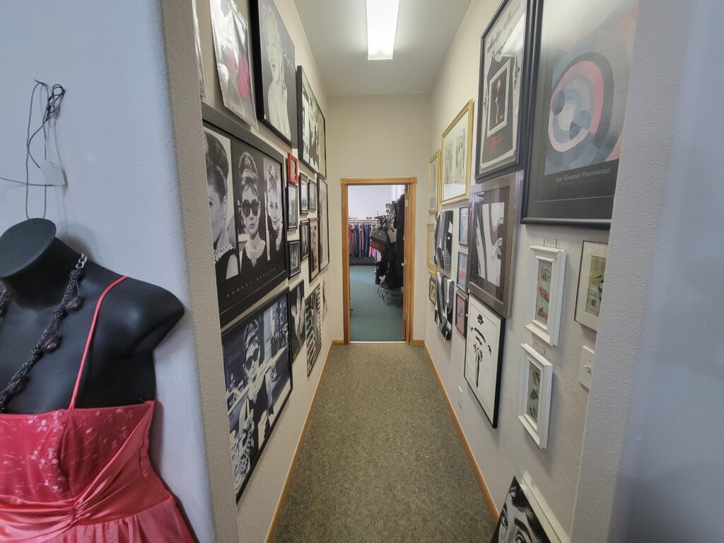 interior hallway lined with framed art on both sides