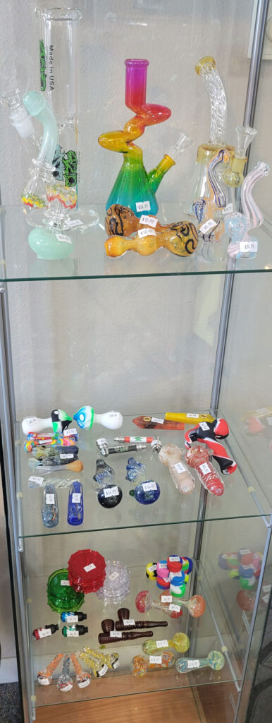 various glass bongs in 3-level display case
